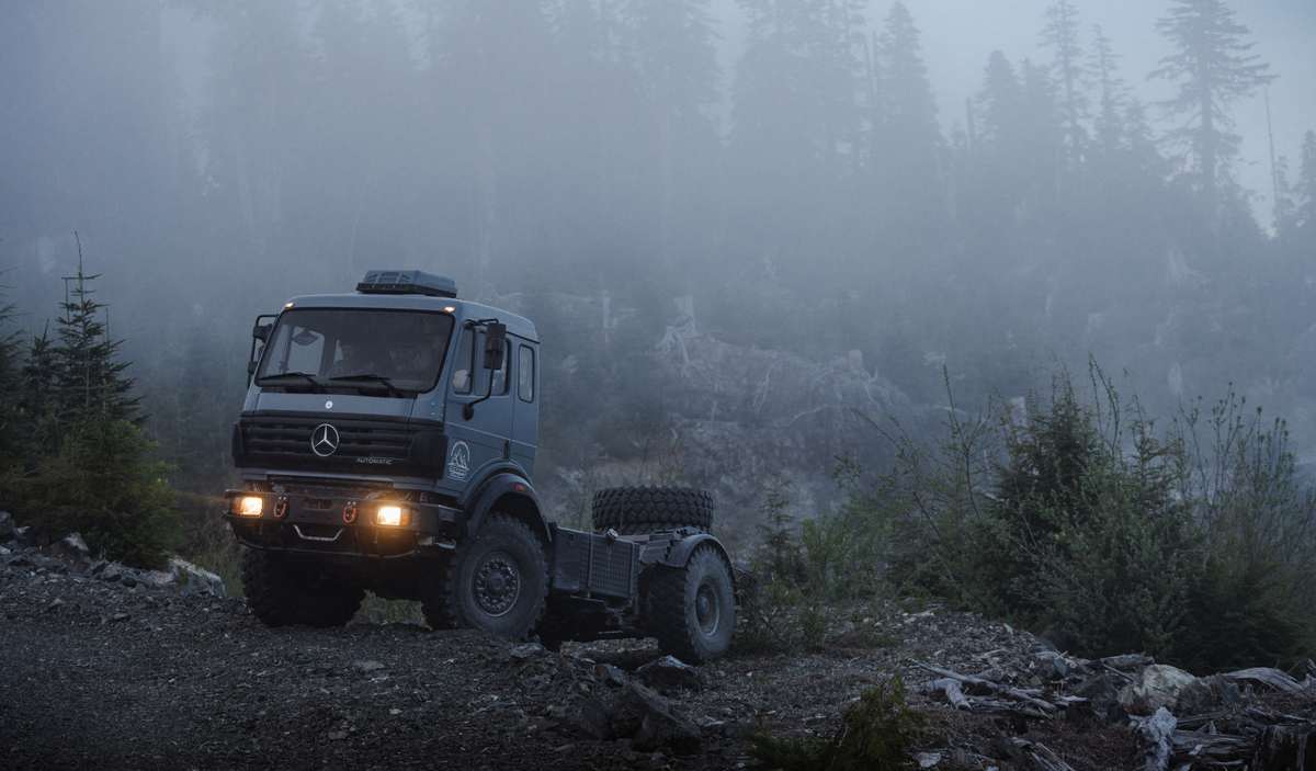 Mercedes-Benz expedition truck chassis in fog on a mountain road
