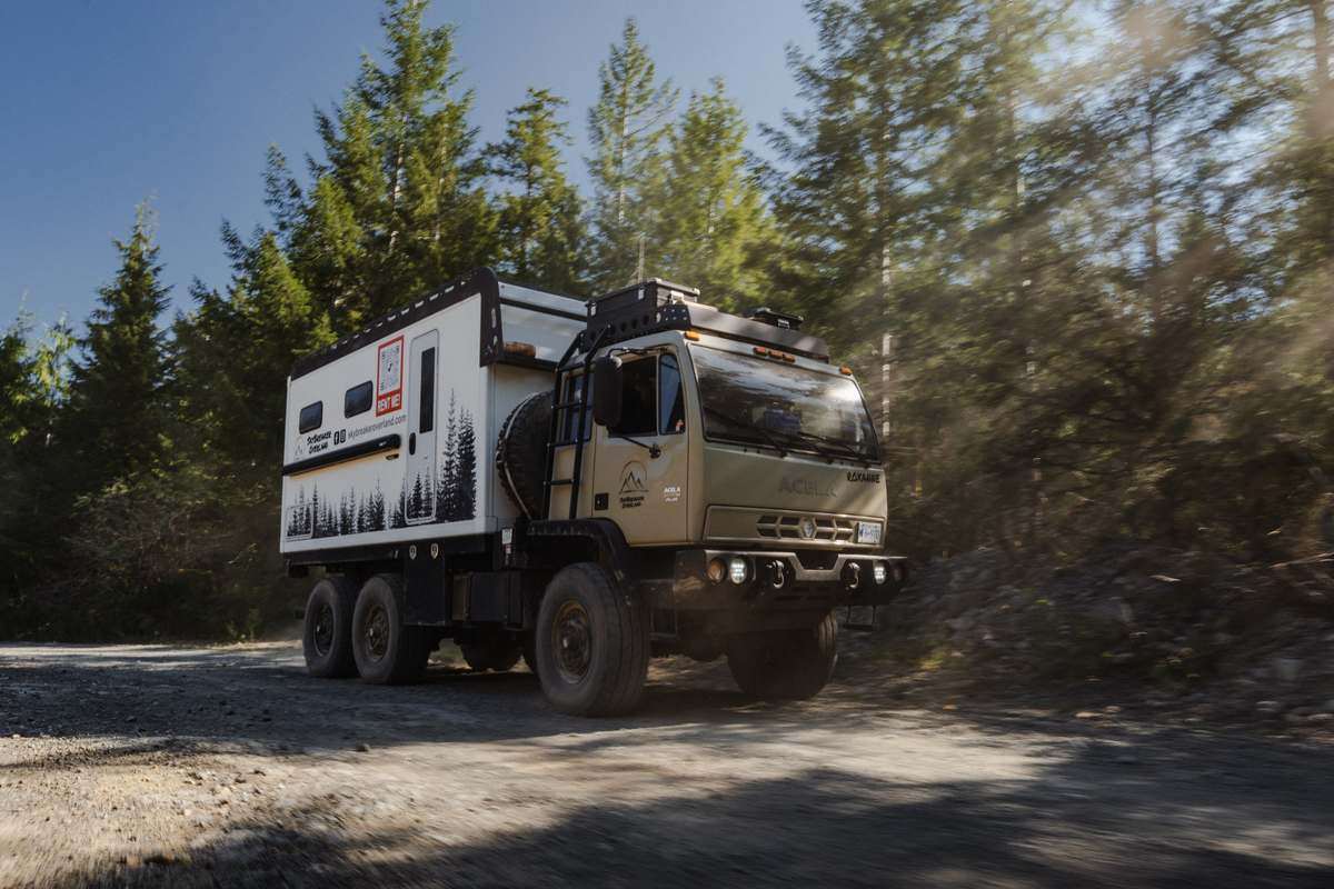 Skybreaker Overland Acela 6x6 on a forest service road in golden light