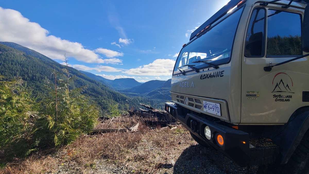 Roxanne, the Acela expedition truck, at a mountain overlook above a valley