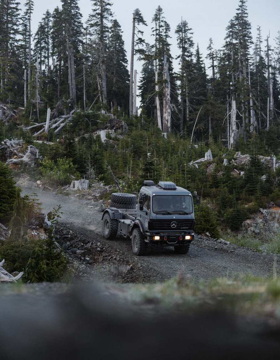 Expedition truck on a switchback through a logged hillside