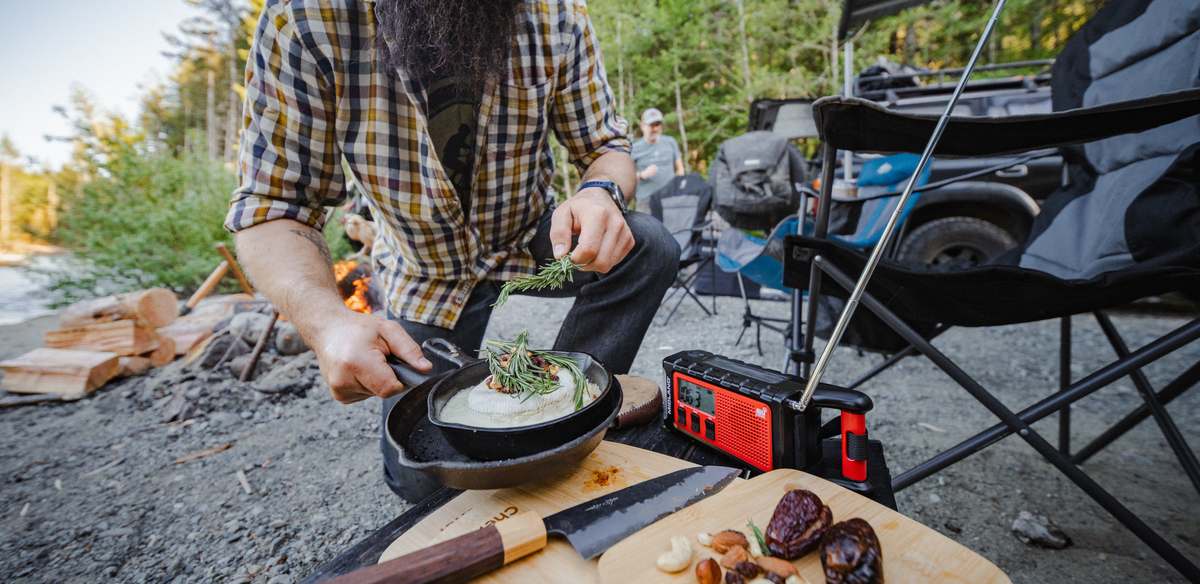 Cooking in a cast iron pan on a camp stove beside the expedition truck