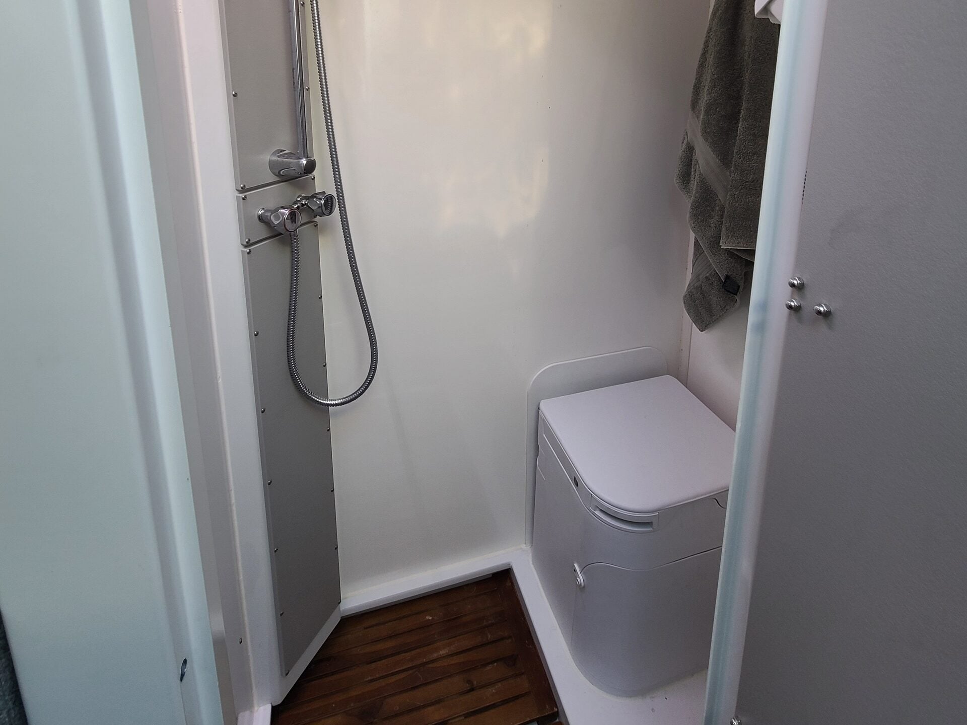 Roxanne's wet bath: shower mixer and handset on the left, toilet on the right, teak slat floor