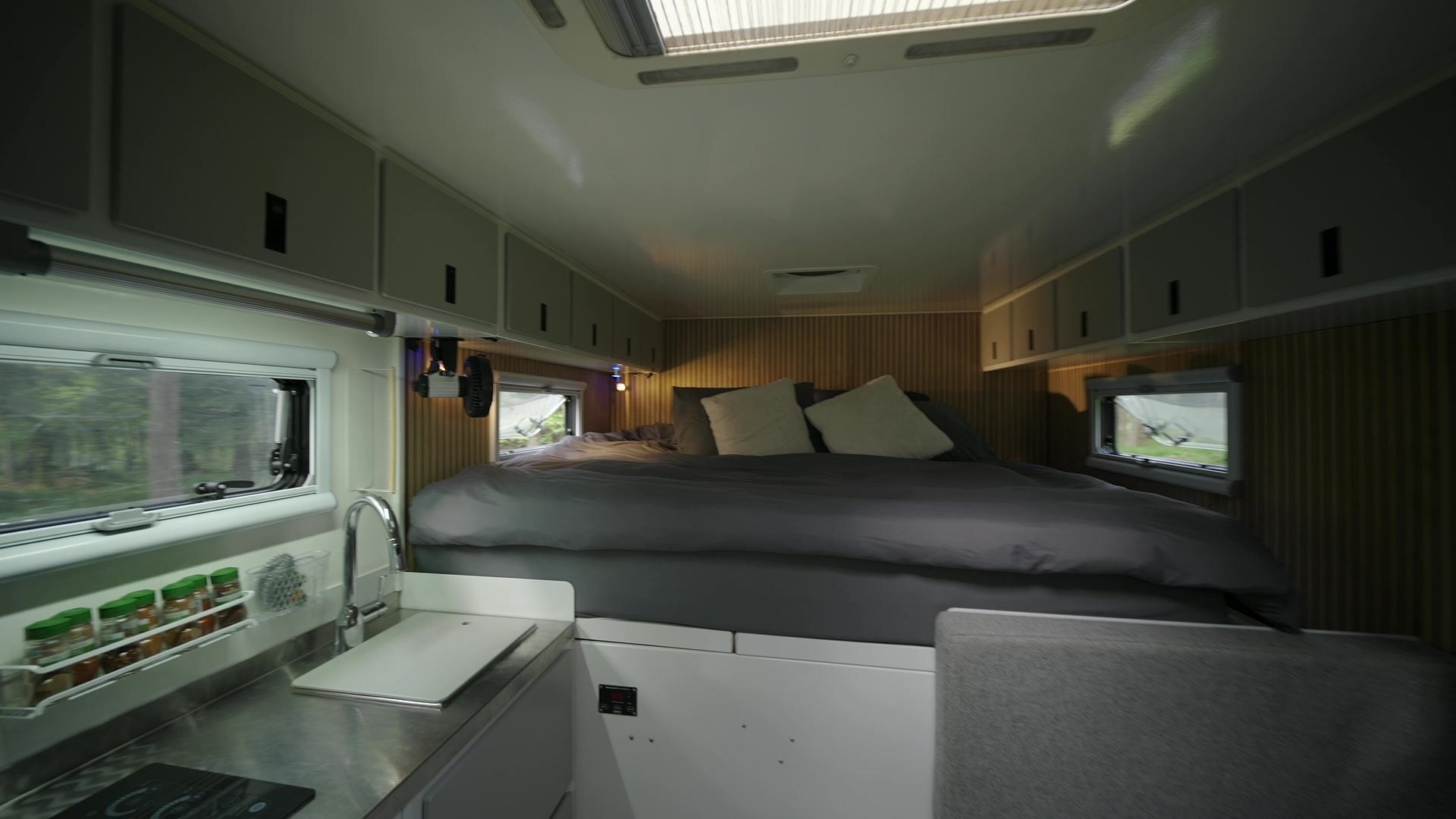 Roxanne's galley and sink in the foreground, looking down the living box to the queen bed