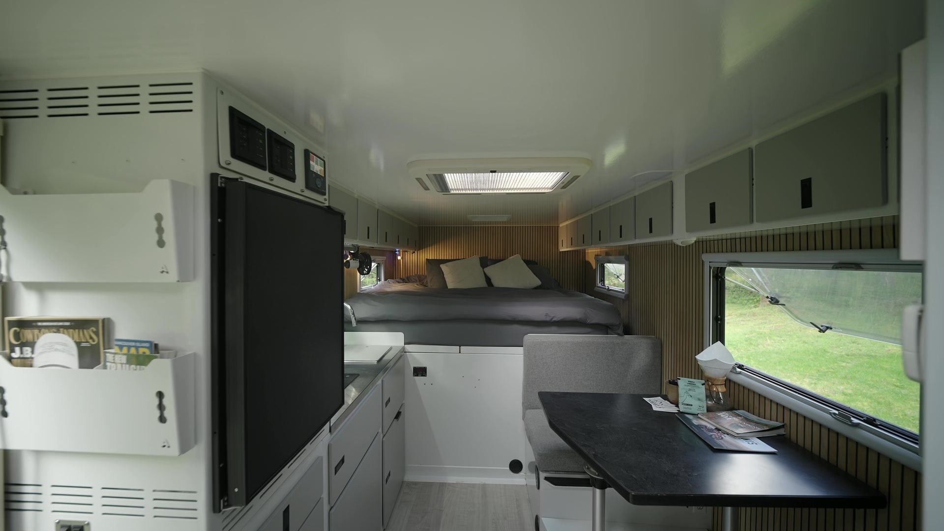 Roxanne's living box from the entry: fridge, galley, dinette and queen bed in one line