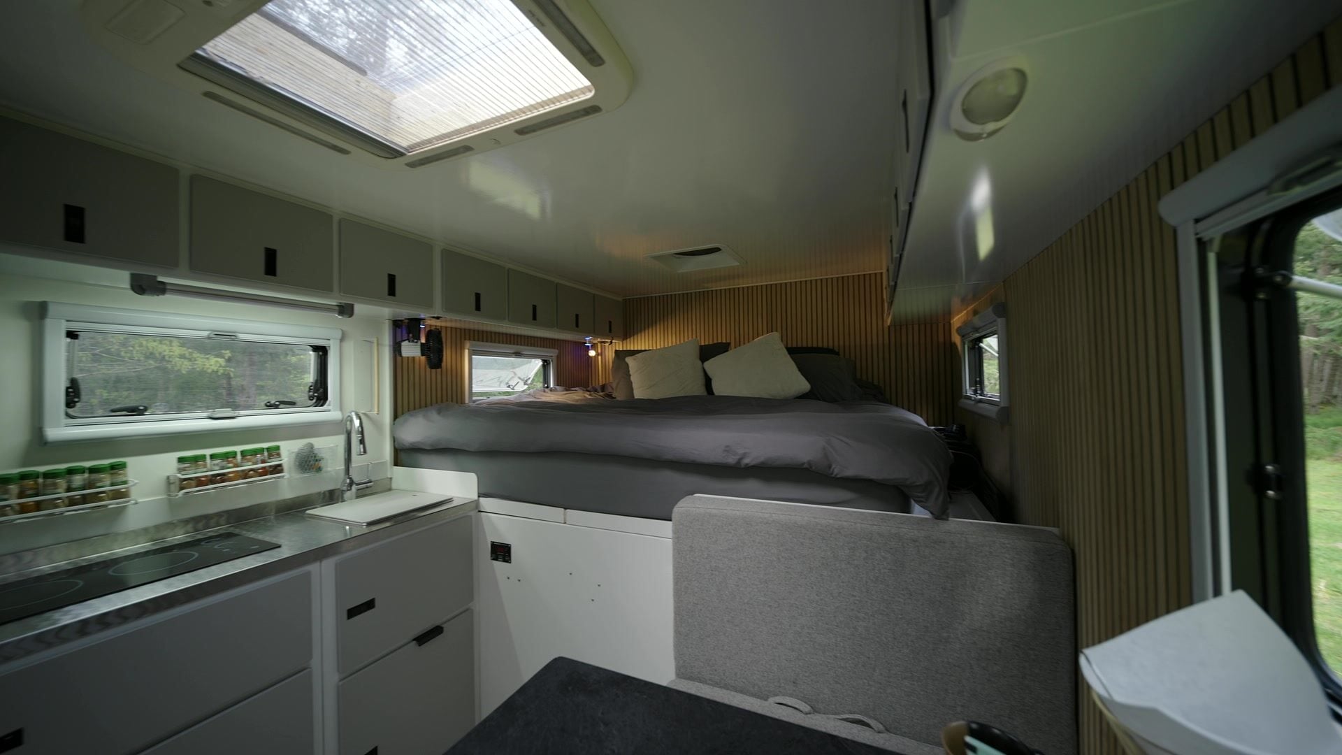 Roxanne's galley and queen bed lit from above by the open roof skylight